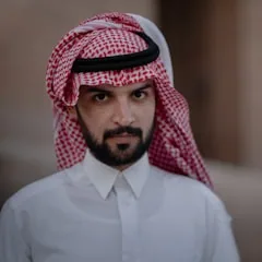 Client wearing a red and white shemagh