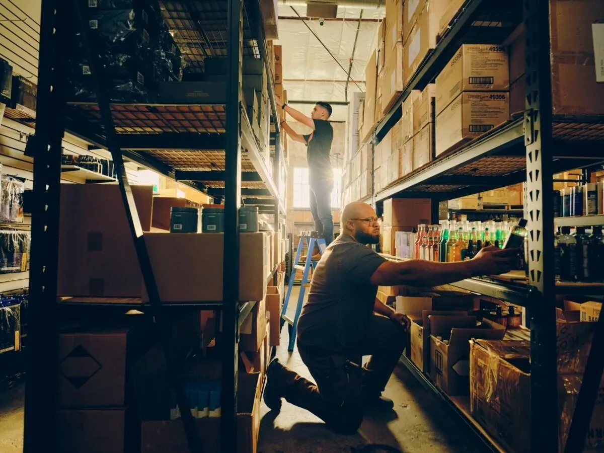 Retail staff stocking shelves in an inventory warehouse